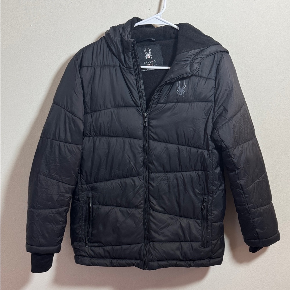 This is a Boy’s Large Spyder black puffer jacket with a hood and thumbhole cuffs